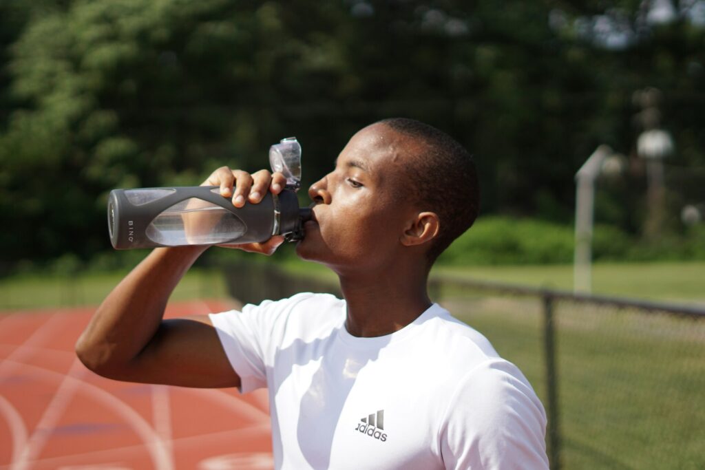 man drinking water during exercise - hydration