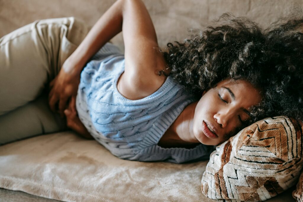 woman having cramps during period, how to workout