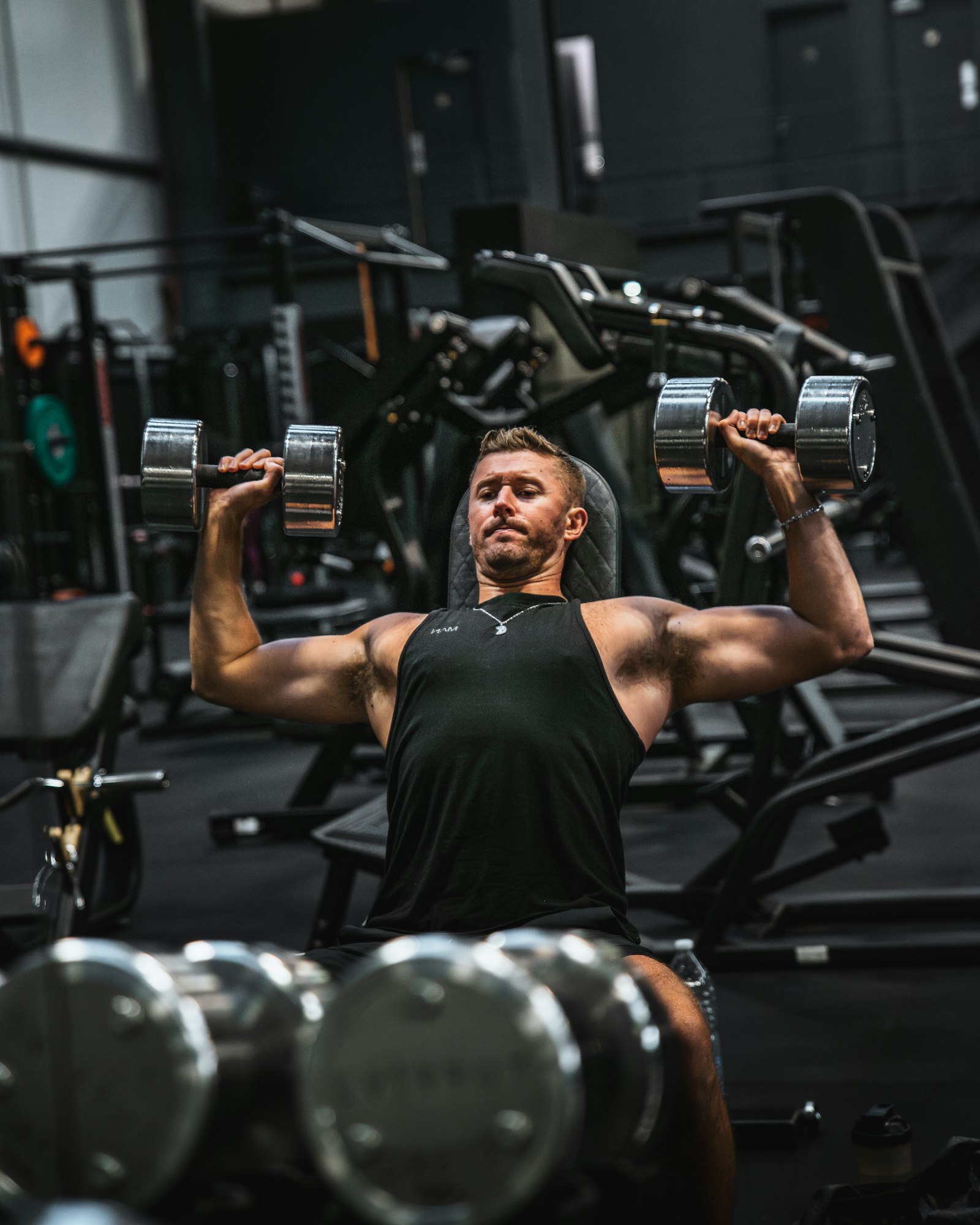 Man doing a seated dumbbell shoulder press