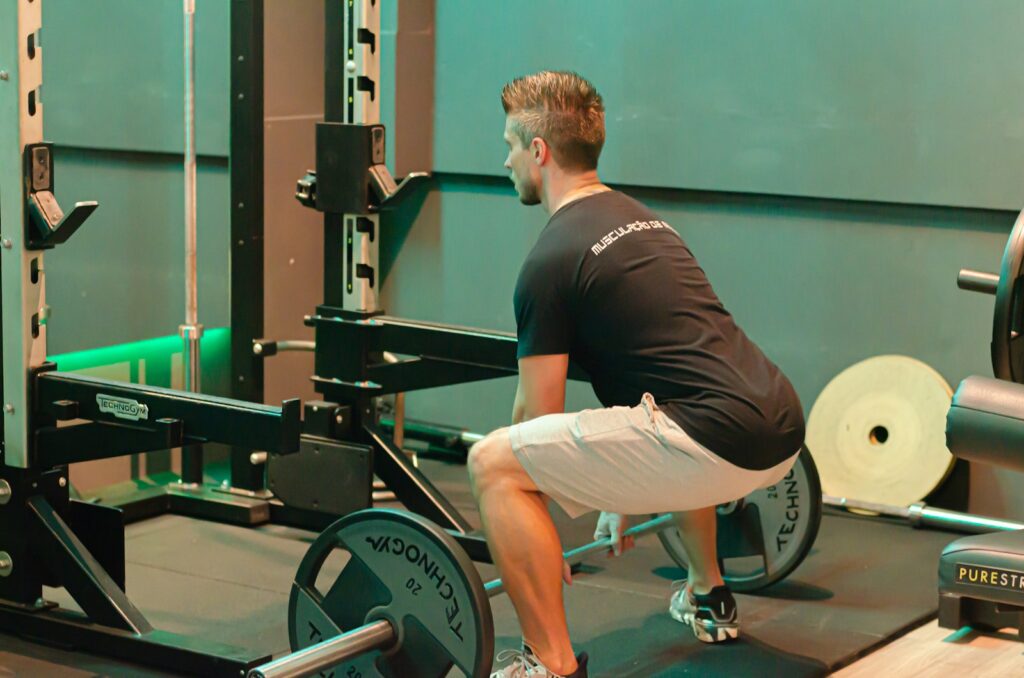 Man in a squat stance showing proper squat form