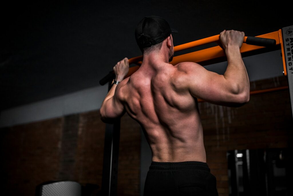 Man doing a pull-up in a gym