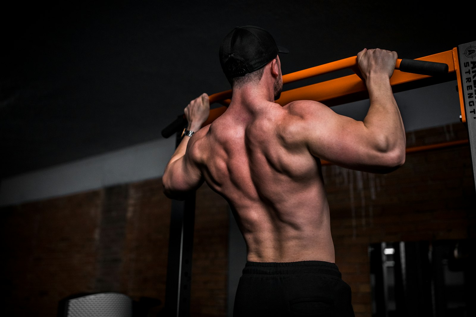 Man doing a pull-up in a gym