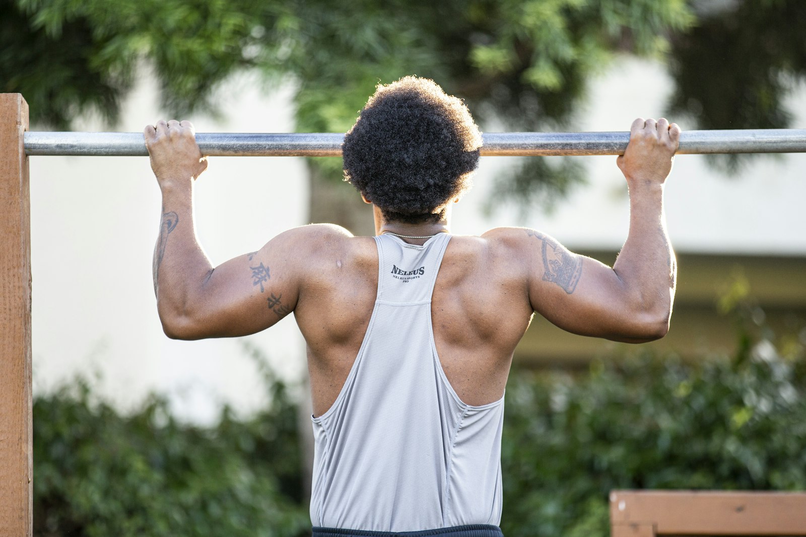 Man doing a pull-up on an outdoor bar
