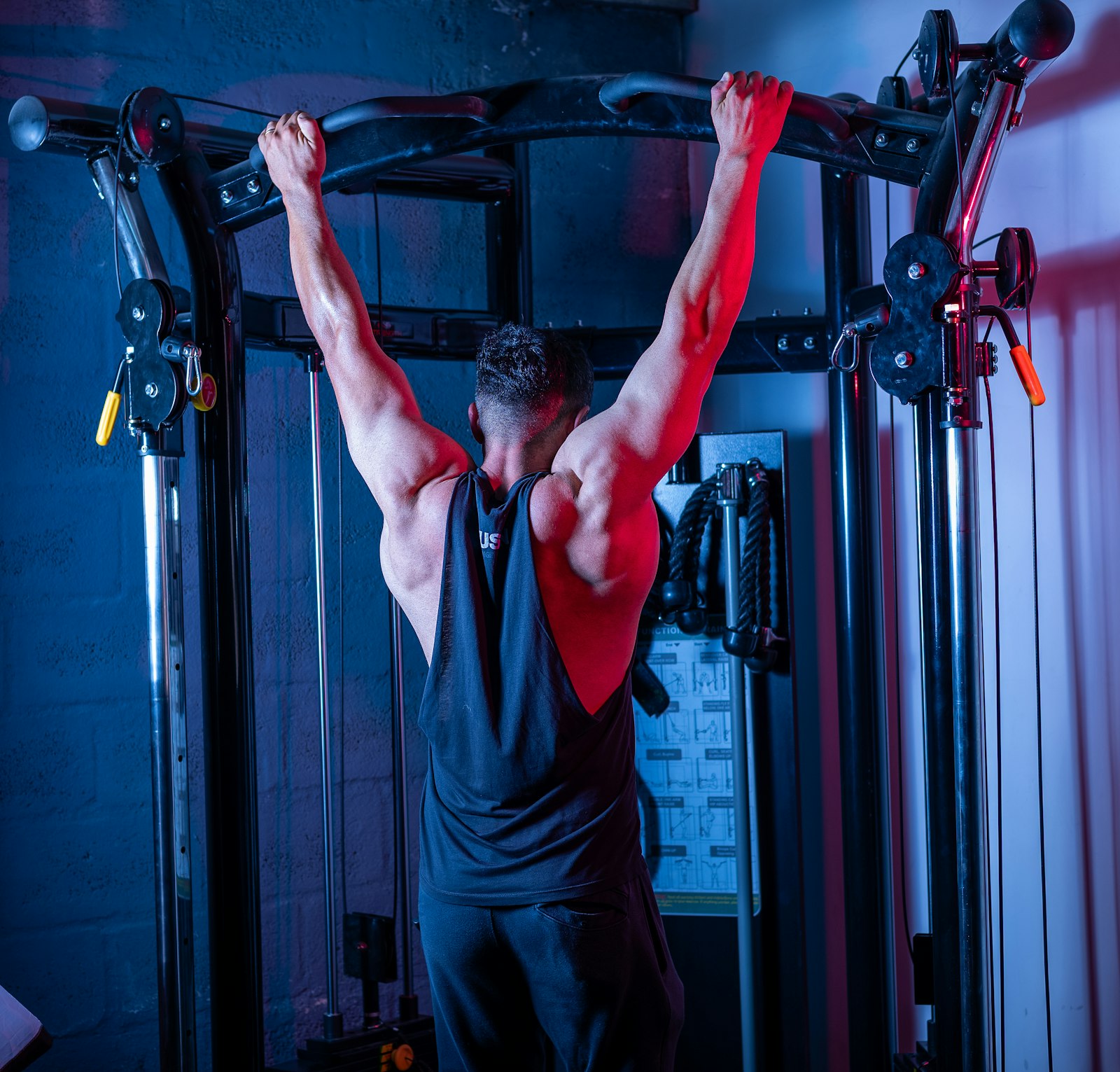 Man hanging from a pull-up bar with a wide grip
