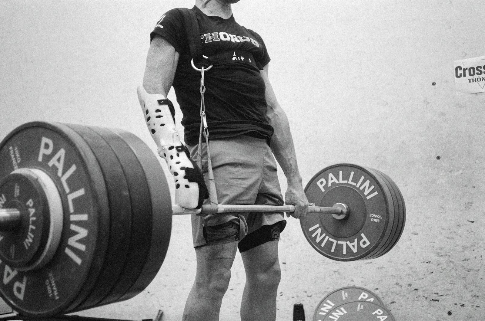Man finishing a heavy barbell deadlift