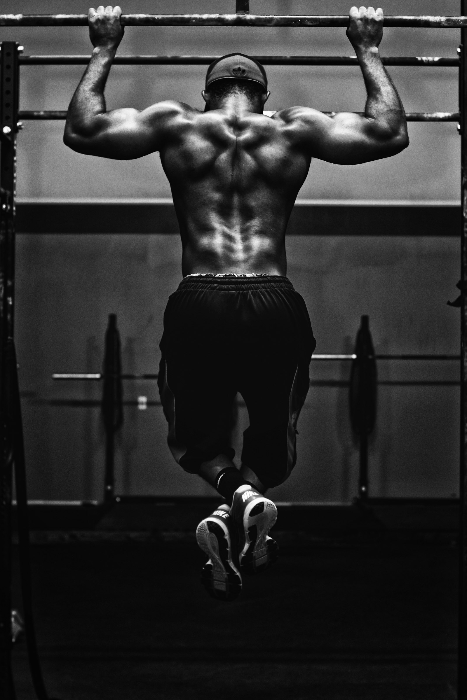 Man doing a strict pull-up with his chin over the bar